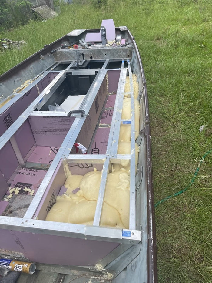 Stripped down boat with expanded closed cell boat pour foam in three of the 10 cavities.