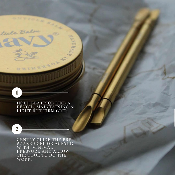 Gold-colored tools and container on a textured surface