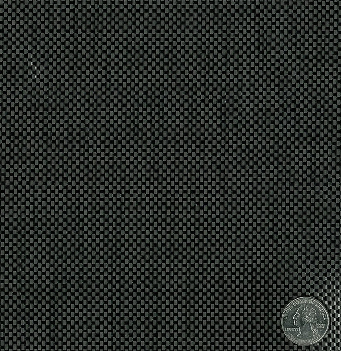 Carbon fiber fabric plain weave close up. Has quarter laying on top for carbon weave size reference.