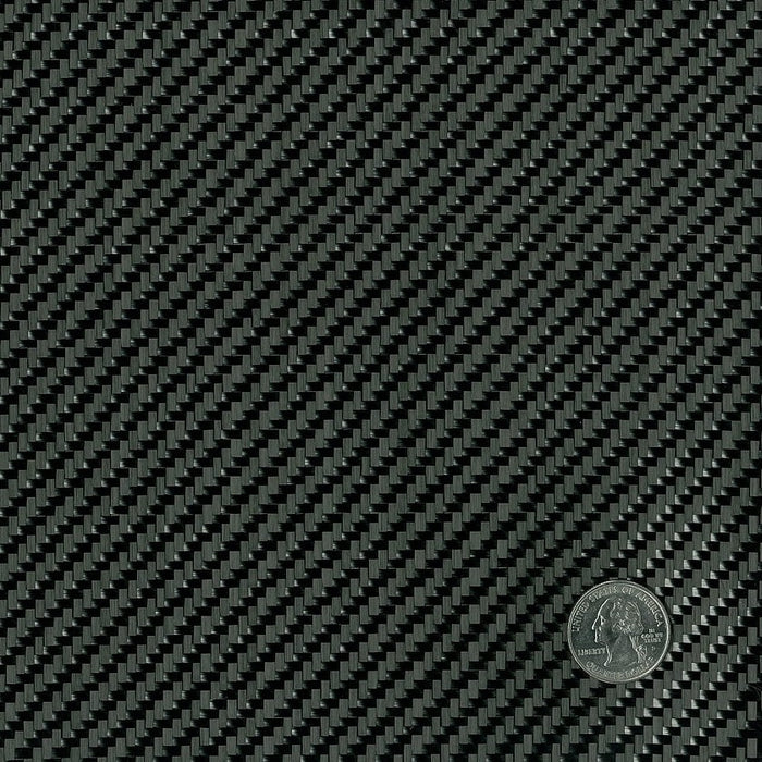 Close up of black twill weave carbon fiber fabric with quarter in the corner for weave size reference.