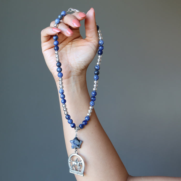 woman holding sodalite horse necklace