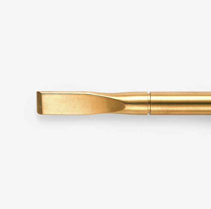 A gold-colored nail removal tool. Designed for the removal of gel and acrylic nail products.