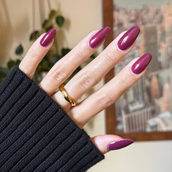 On the Promenade - Gel on long almond-shaped nails in shimmering mulberry purple for a glossy manicure by Olive and June