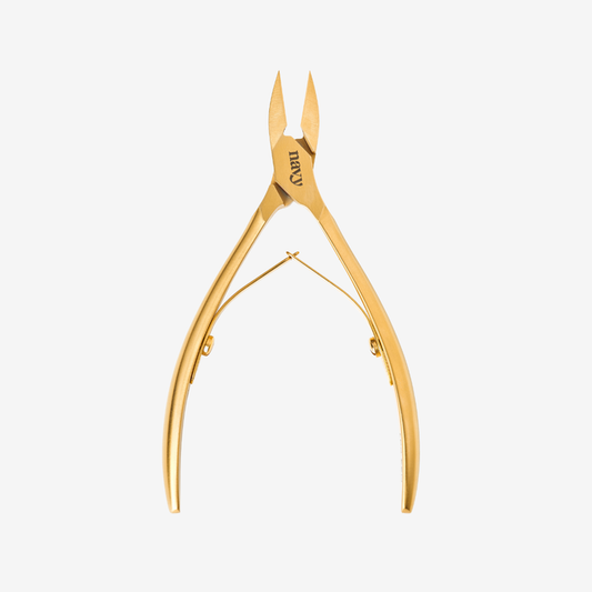Gold nail clippers on a white background
