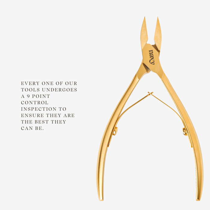 Gold nail clipper on a white background with text about quality control.