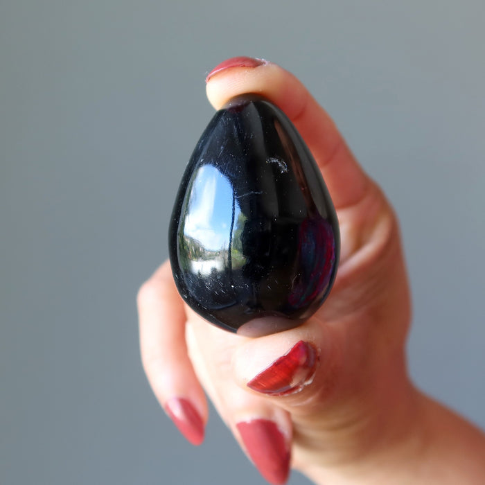 hand holding black agate egg