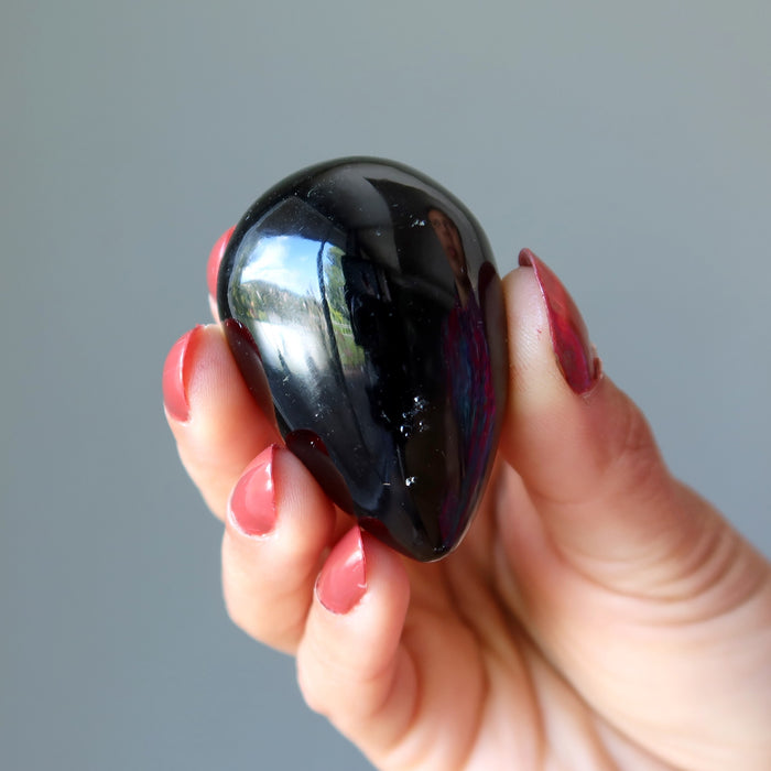 hand holding black agate egg