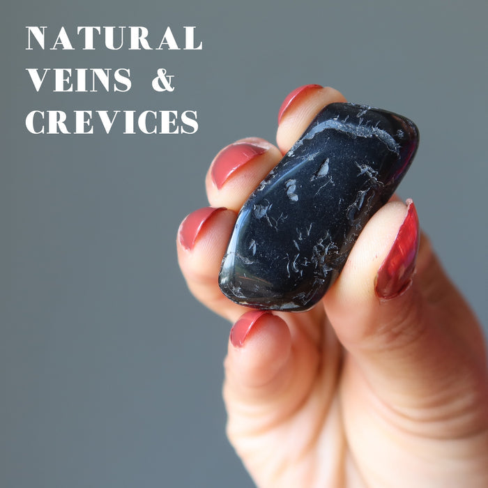 hand holding black tourmaline tumbled