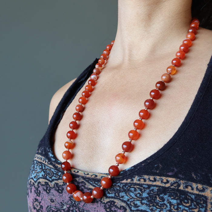 woman modeling carnelian copper beaded necklace