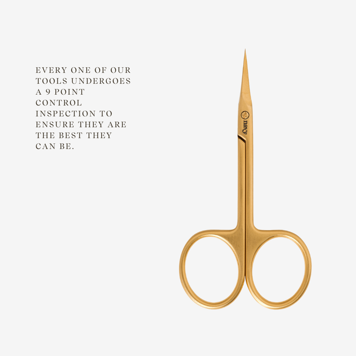 Gold scissors on a white background with text about quality control.
