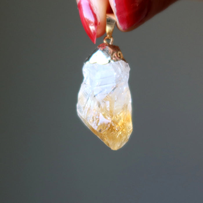 hand holding citrine raw pendant