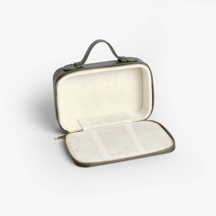 Green travel case with a white interior on a light gray background