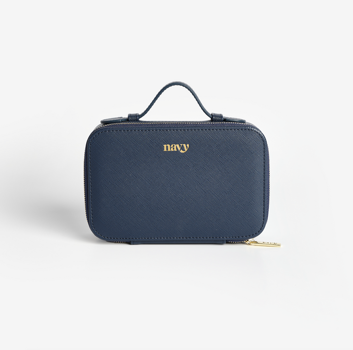 A navy faux leather storage case with a gold zip and the brand name 'Navy' written in gold on the front. Manicure