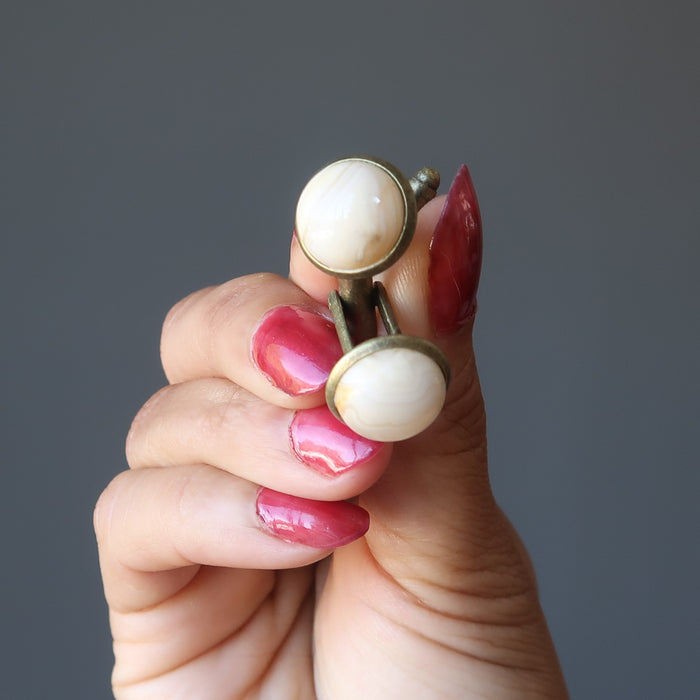 hand holding crazy lace agate cufflinks
