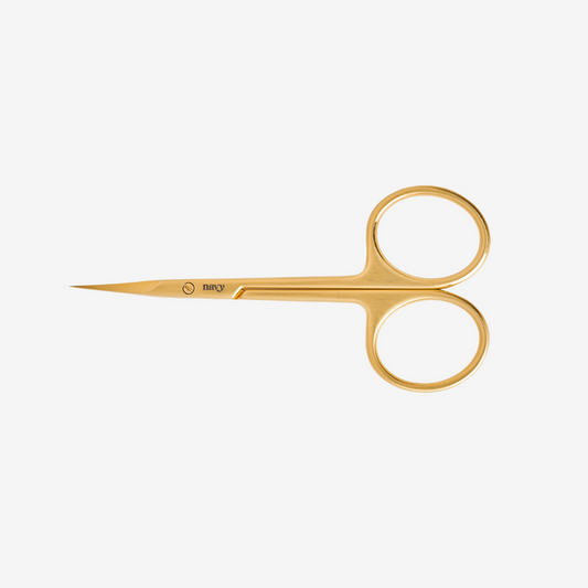 Pair of gold nail manicure scissors on a white background