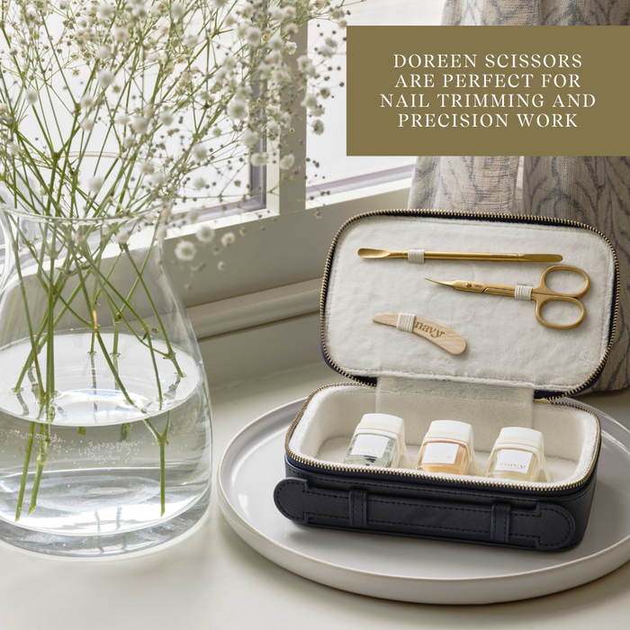 Doreen scissors set in a case on a table with a vase of flowers in the background