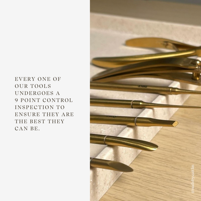 Gold tools arranged on a wooden surface with text about quality control.