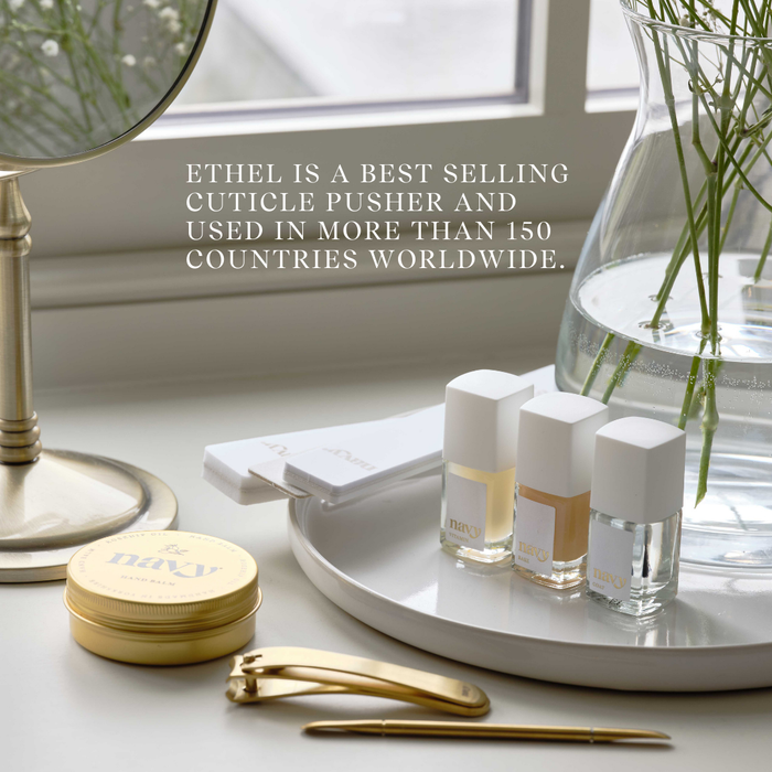 Cosmetic products on a tray with text about Ethel cuticle pusher