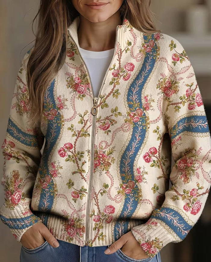 Ivory zip-front cardigan with pink climbing rose print and blue ribbon bands, ribbed collar and cuffs