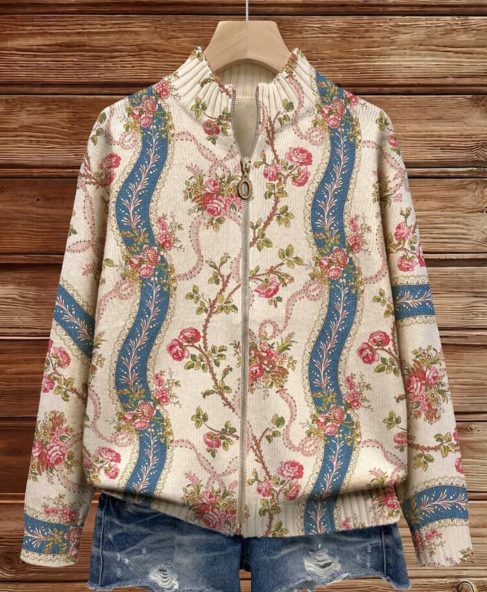 Ivory zip-front cardigan with pink climbing rose print and blue ribbon bands, ribbed collar and cuffs