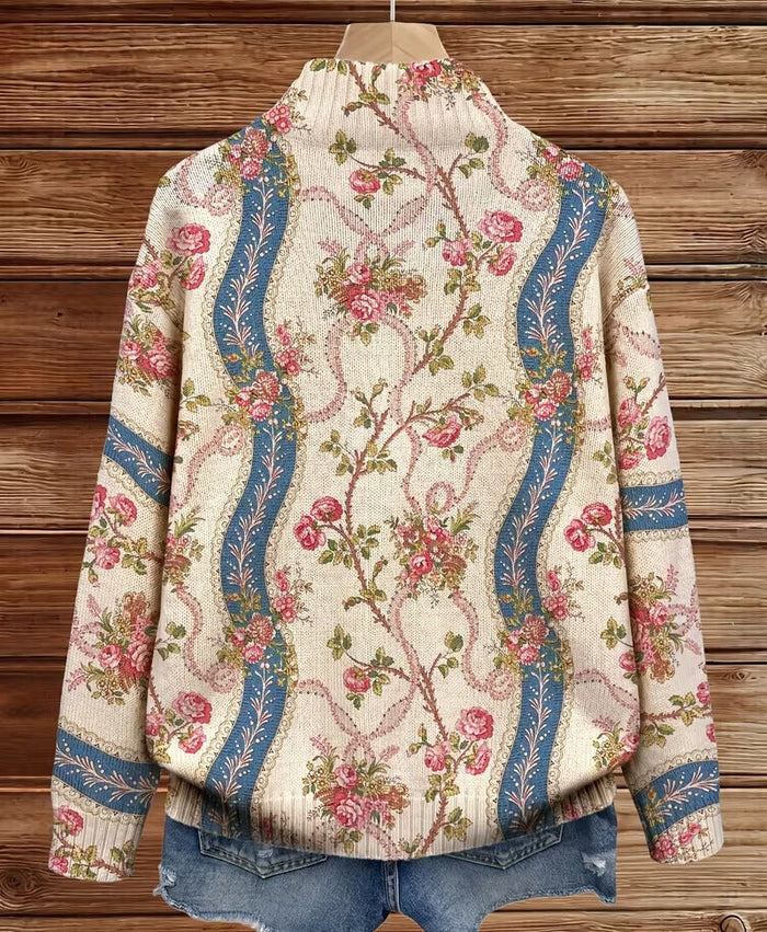 Ivory zip-front cardigan with pink climbing rose print and blue ribbon bands, ribbed collar and cuffs