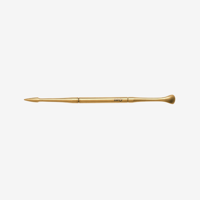 Gold makeup brush on a white background