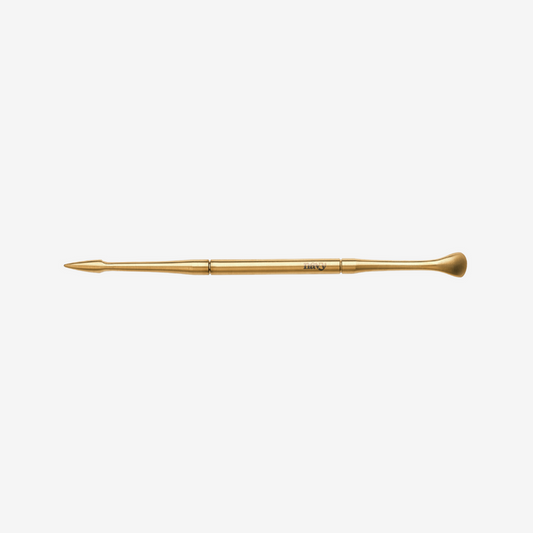 Gold makeup brush on a white background