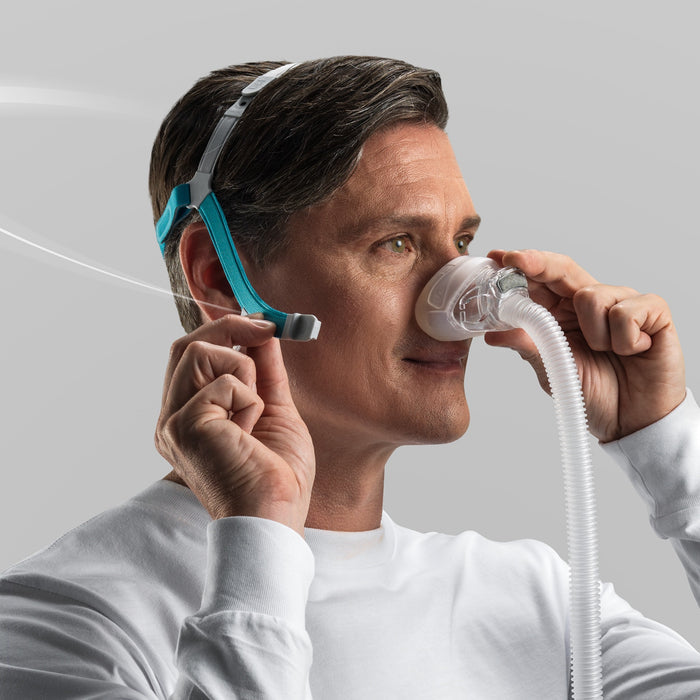 Man using a CPAP device with a white background