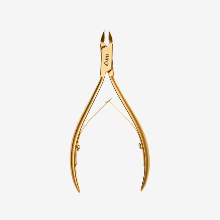 Gold-colored nail clipper on a white background