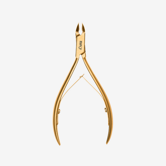 Gold-colored nail clipper on a white background