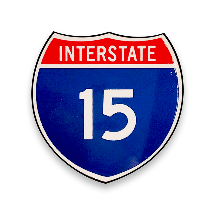 Interstate 15 road sign with red top and blue bottom on a white background.