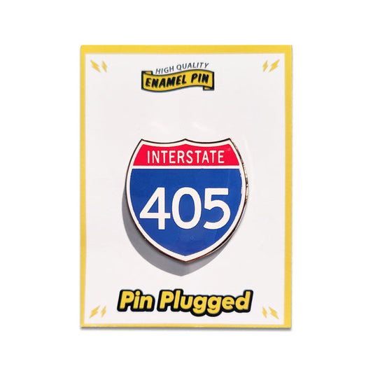 Enamel pin of an interstate 405 sign on a white background with 'Pin Plugged' branding.