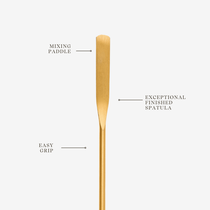 Gold spatula with text labels on a white background
