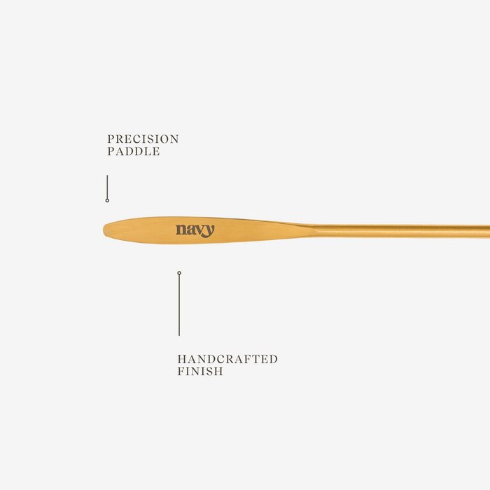 Wooden paddle with 'navy' branding on a white background