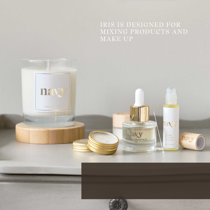 Makeup products including a candle, bottles, and containers on a neutral background with 'Navy' branding.