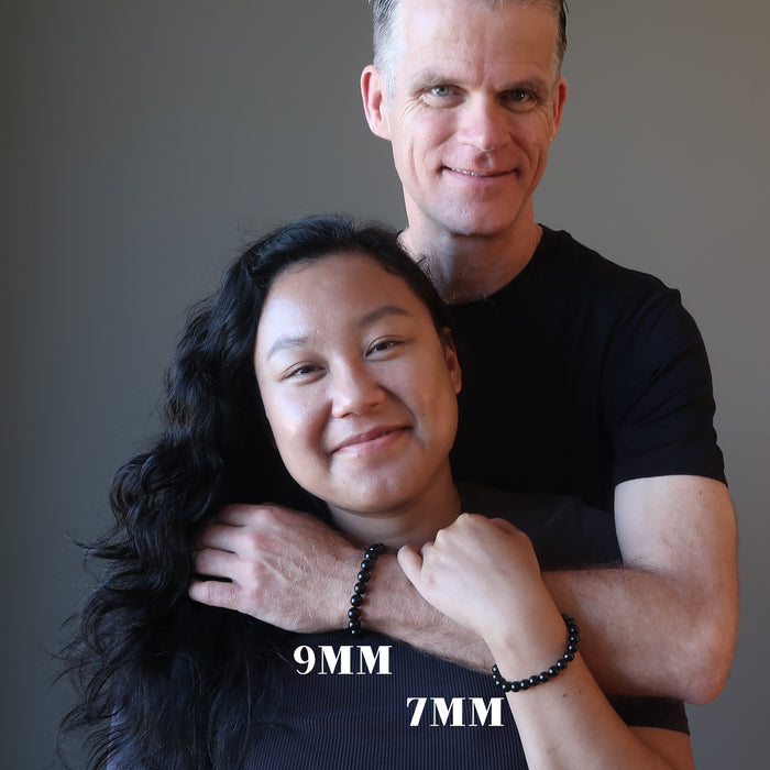 ryan and jessica of satin crystals hugging and wearing black jet stone round beaded stretch bracelet