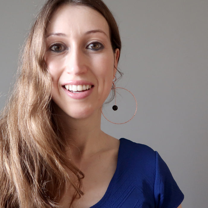 holly from satin crystals wearing jet stones in big copper hoop earrings