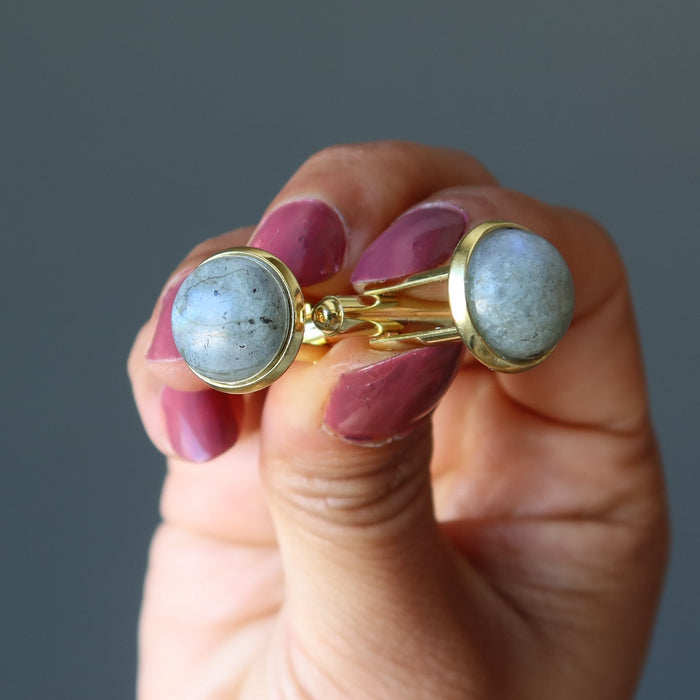 hand holding labradorite cufflinks