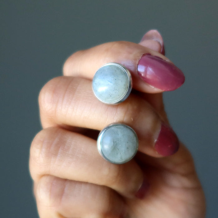 hand holding labradorite silver cufflinks