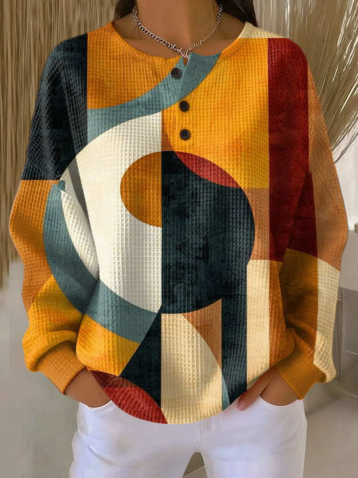 Orange waffle knit sweater with geometric pattern and relaxed fit