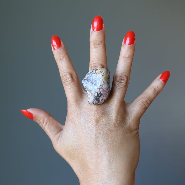 open hand wearing leopard jasper ring
