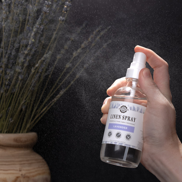 Rustic Strength, hand shown spraying Linen Spray with fresh mist surrounding