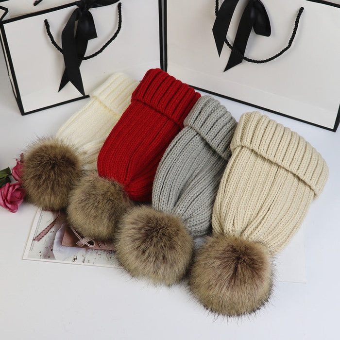 Classic cozy knit beanie with a plush pom accent shown in multiple colors