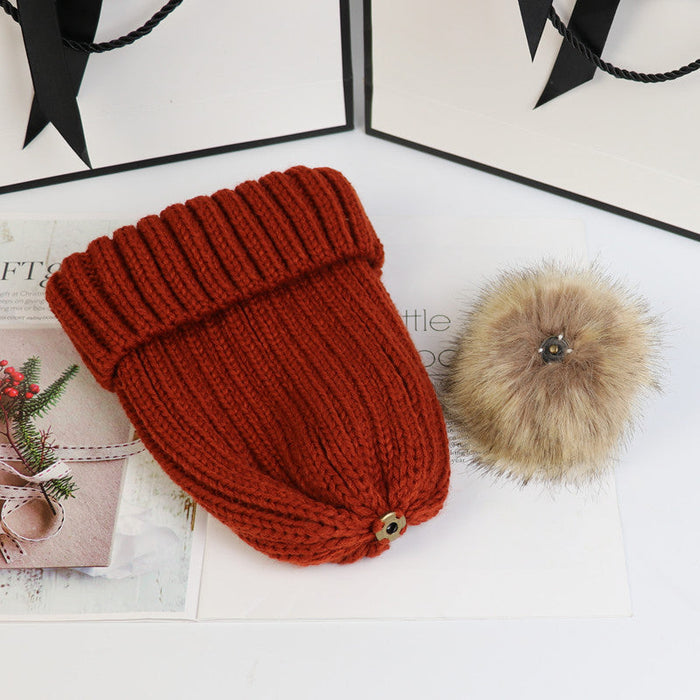 Classic cozy knit beanie with a plush pom accent shown in multiple colors