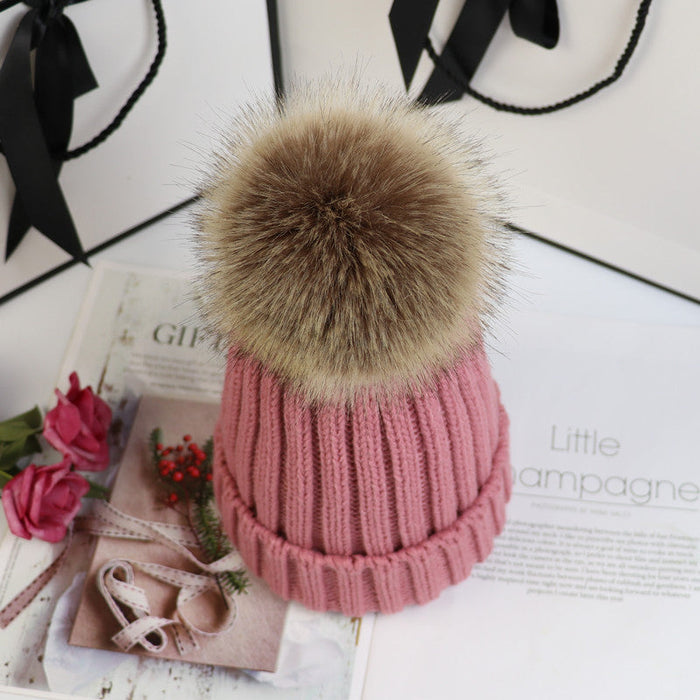 Classic cozy knit beanie with a plush pom accent shown in multiple colors