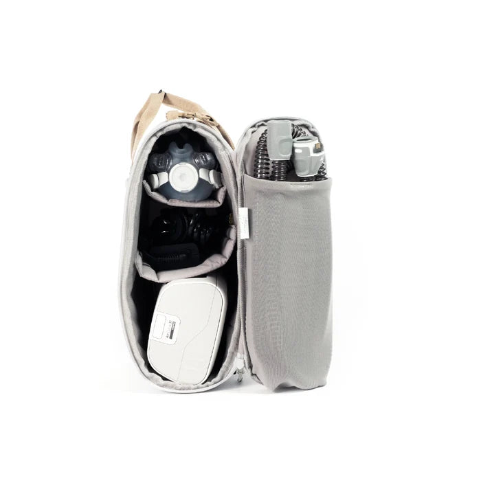 CPAP insert bag shown open, with a cpap machine and cpap mask accessories, on clean white background.