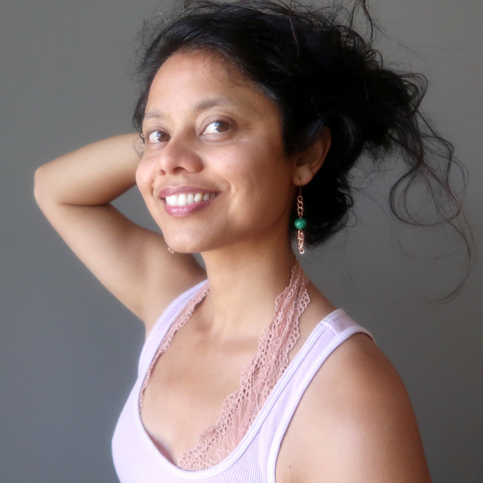 woman wearing malachite copper chain earrings