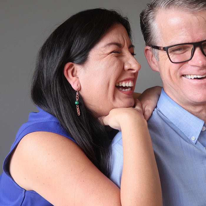 woman wearing malachite copper chain earrings laughing with man