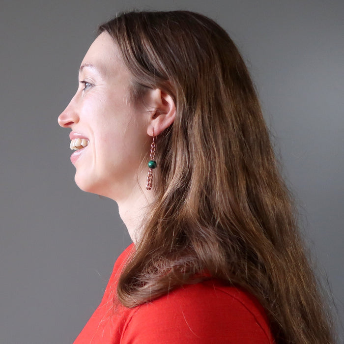woman wearing malachite copper chain earrings