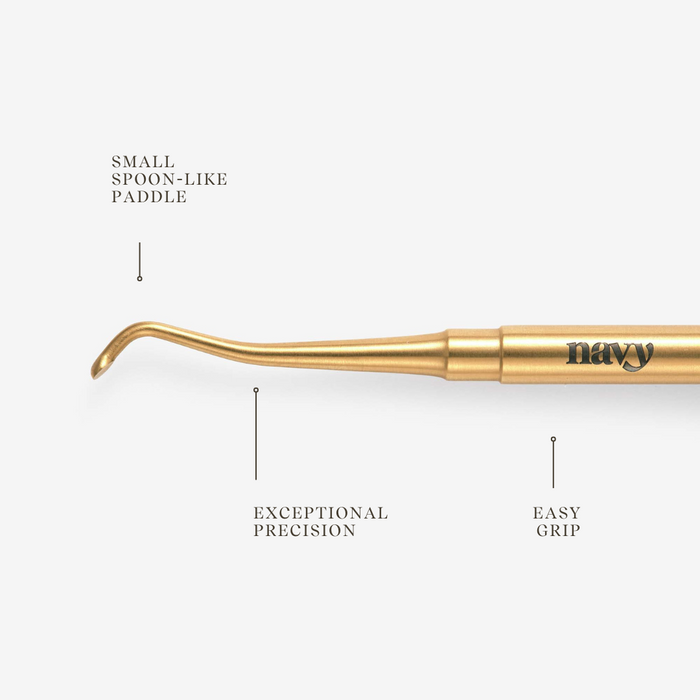Gold manicure tool with features labeled on a white background